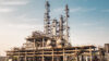 Industrial chemical processing plant with tall distillation columns and storage vessels