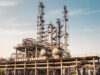 Industrial chemical processing plant with tall distillation columns and storage vessels
