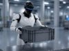 Humanoid robot holding a plastic container in an industrial facility