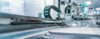 Automated manufacturing equipment operating on a high-precision production line, performing industrial processing and assembly tasks in a modern factory environment.