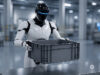 Humanoid robot holding a plastic container in an industrial facility
